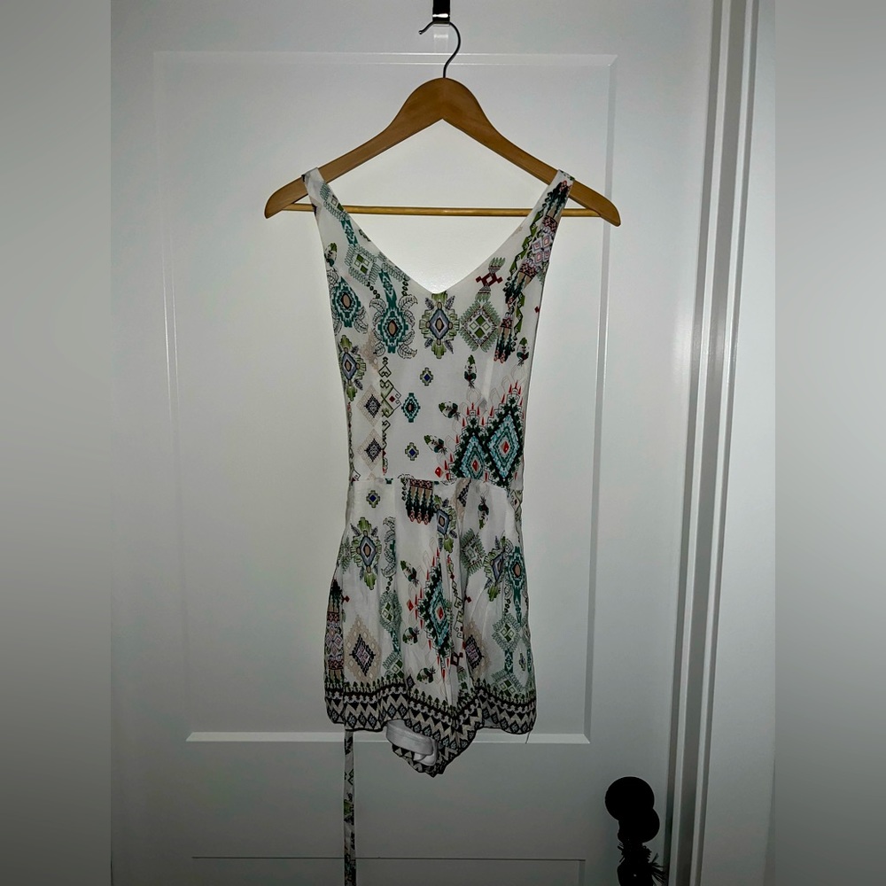 white romper with asymmetrical pattern and cross-cross back. like new.
